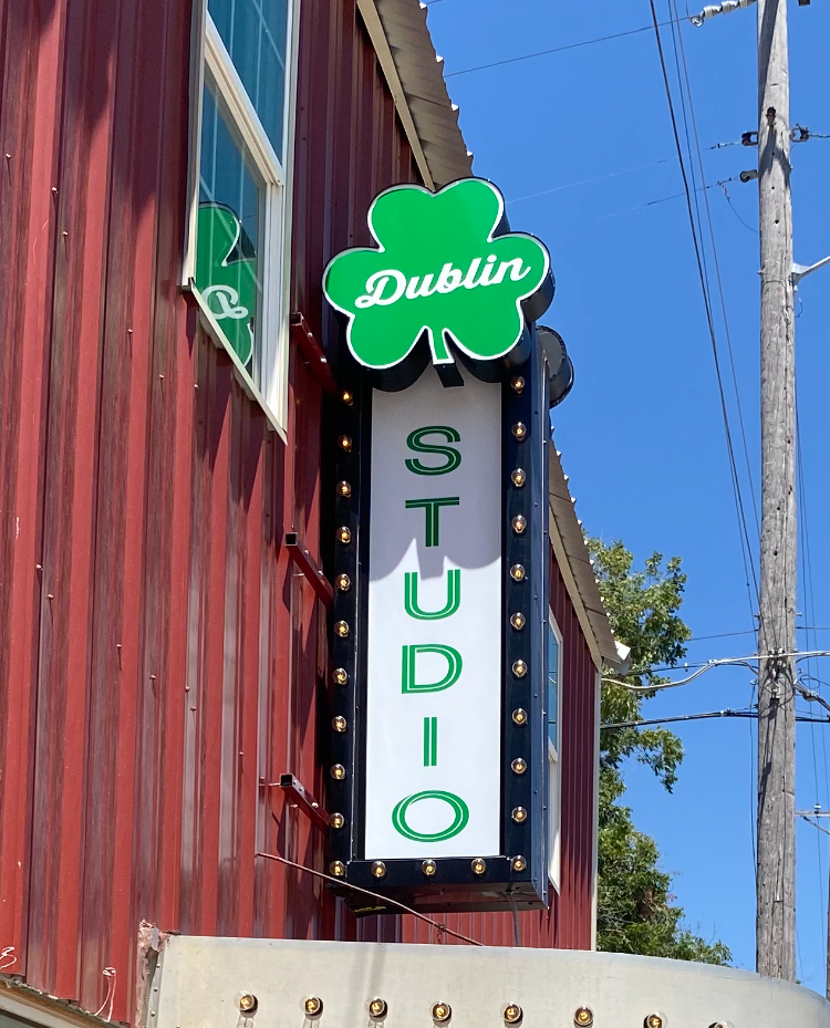 Illuminated shamrock marquee sign for Dublin Studio in downtown Dublin, TX