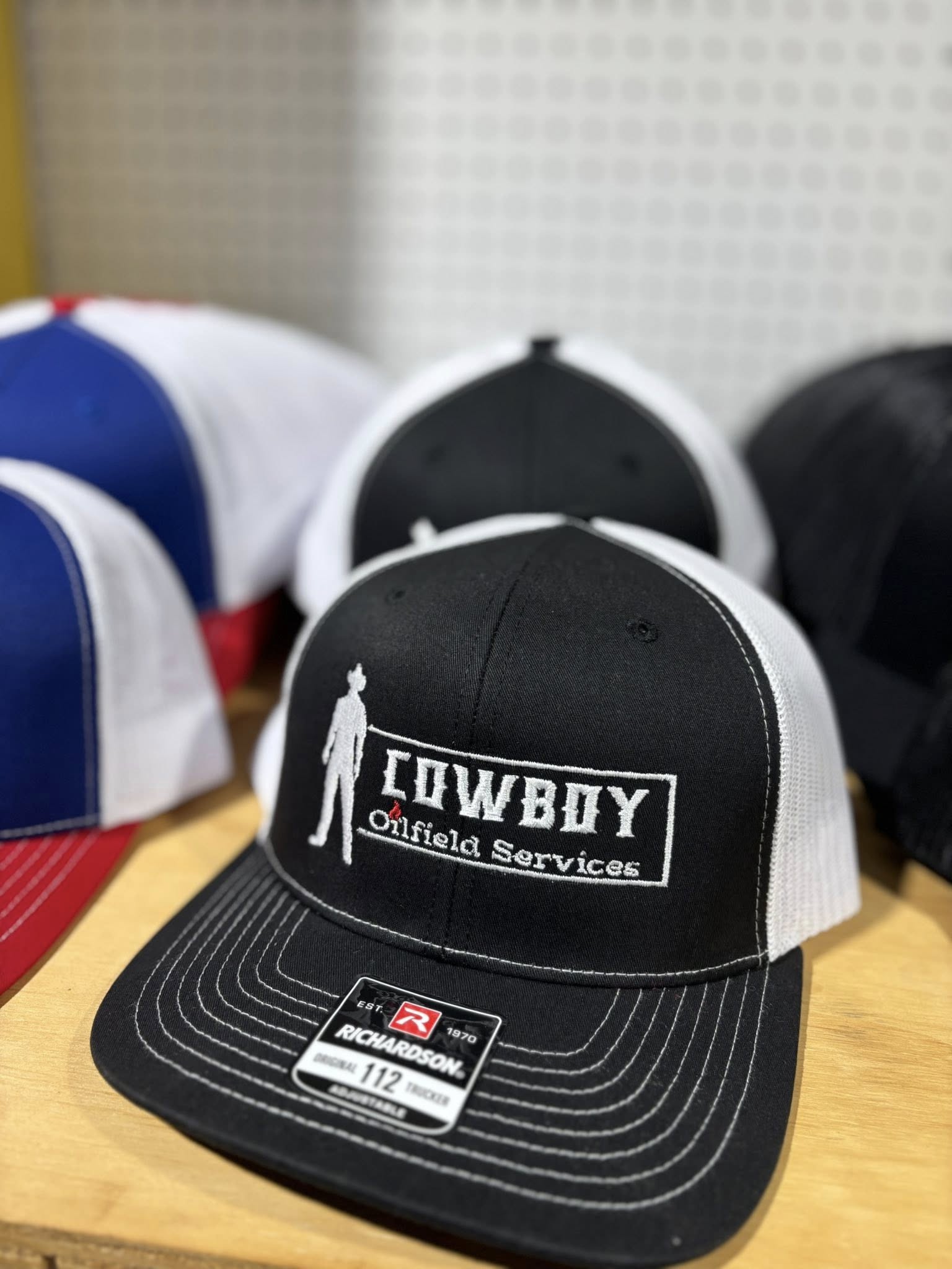 Embroidered Cowboy Oilfield Services logo cap with cowboy silhouette design