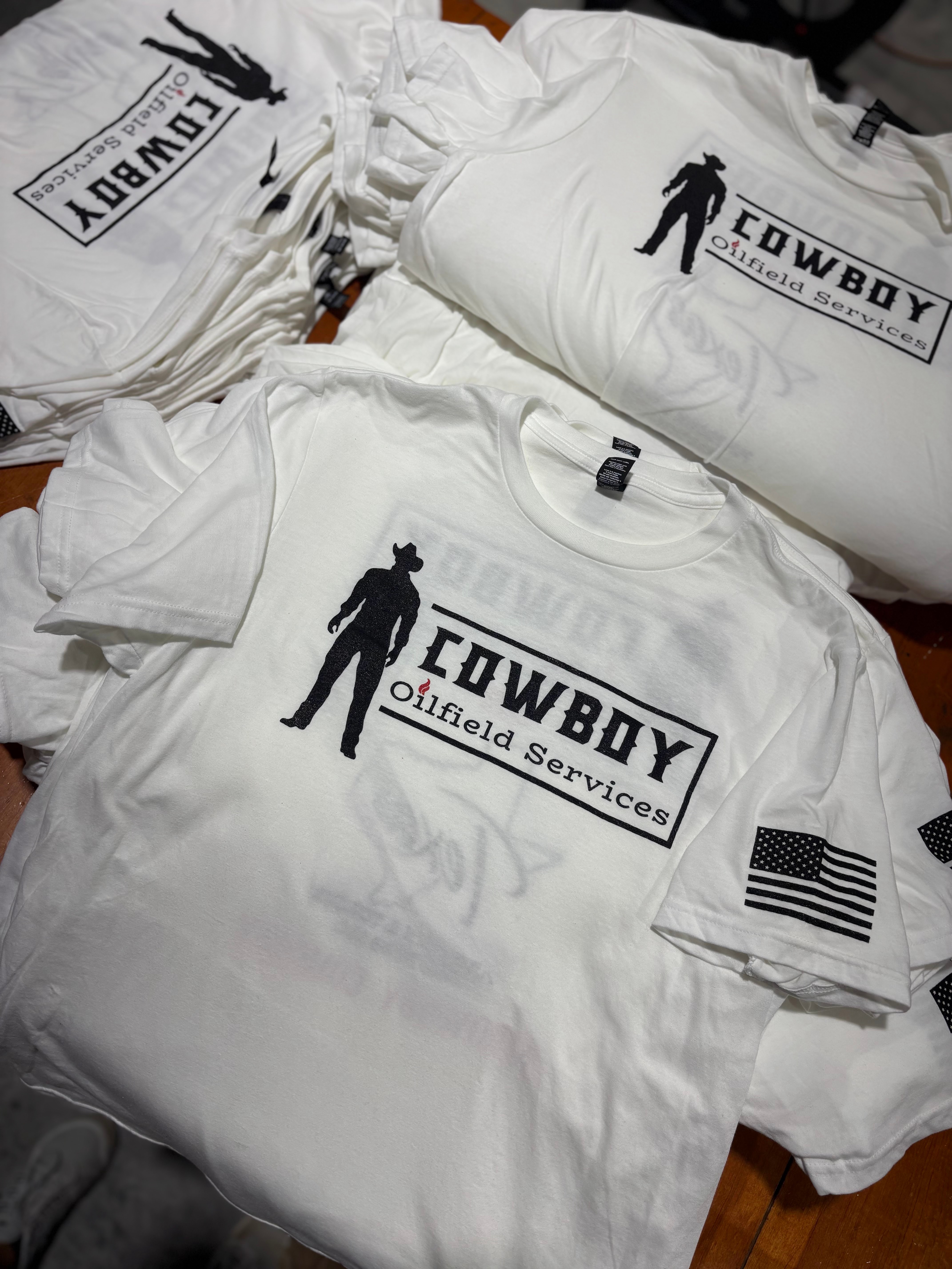 White screen-printed Cowboy Oilfield Services t-shirts with American flag sleeve print