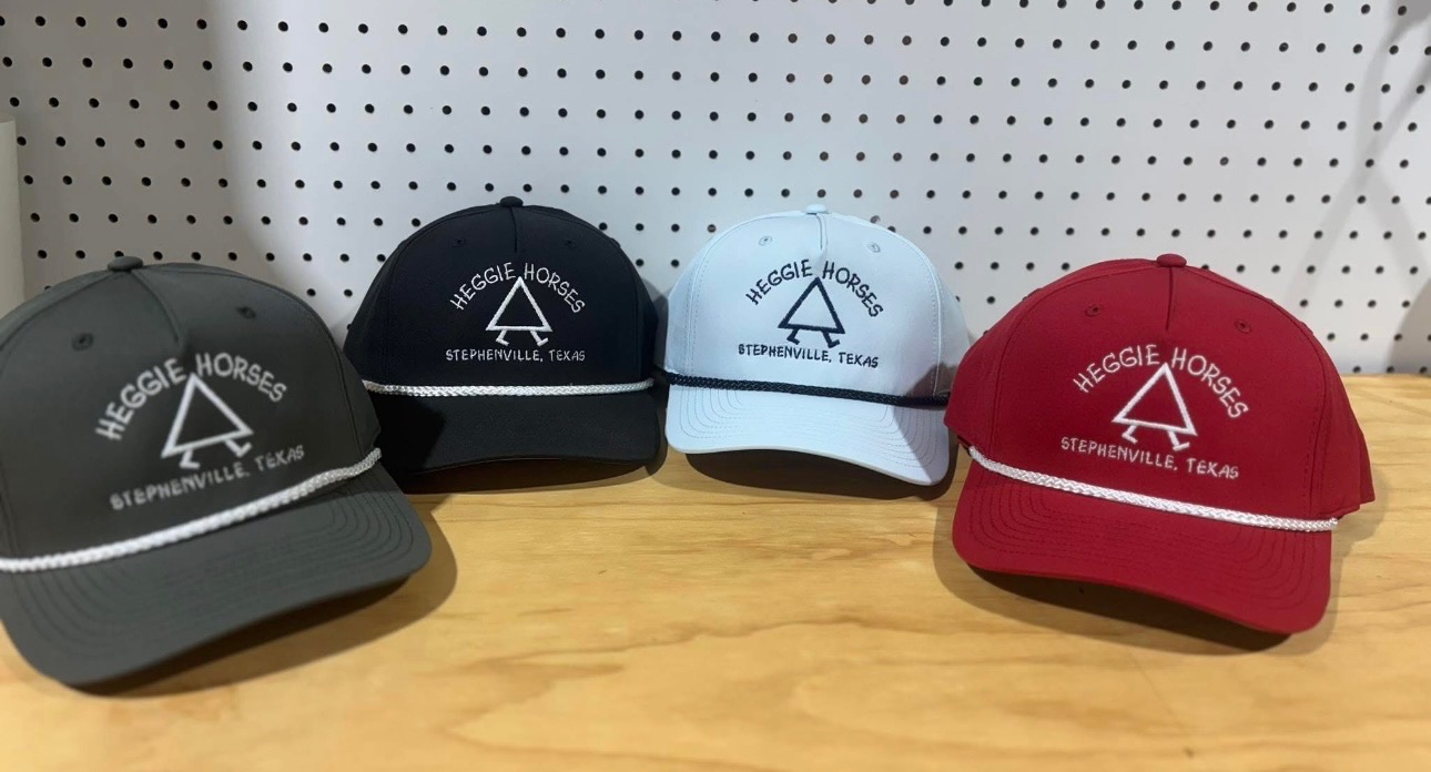 Embroidered Heggie Horses trucker caps in gray, black, white, and red with Stephenville, Texas lettering