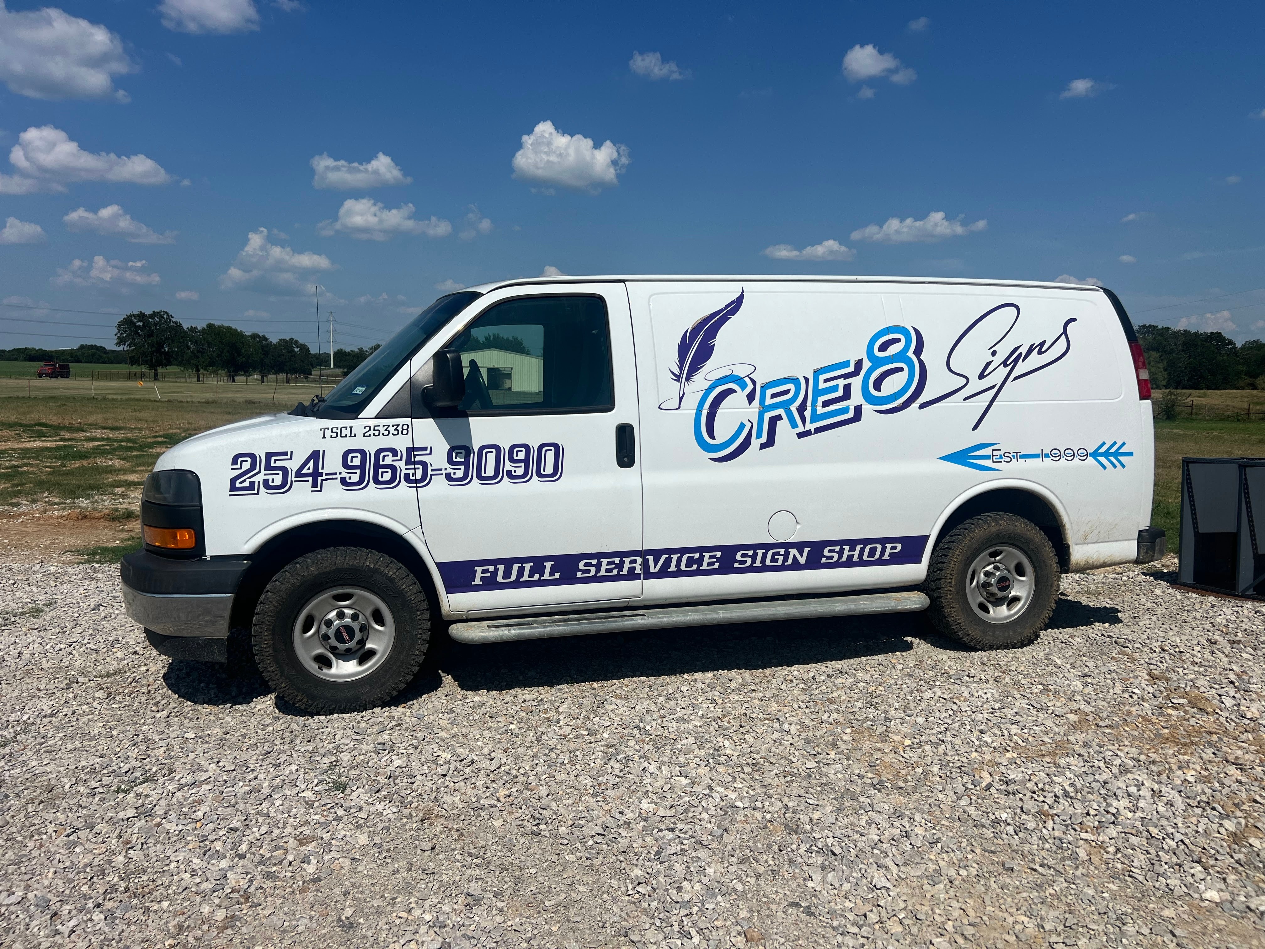 Cre 8 Signs & Grafixs work van with custom logo, phone number, and full-service sign shop lettering