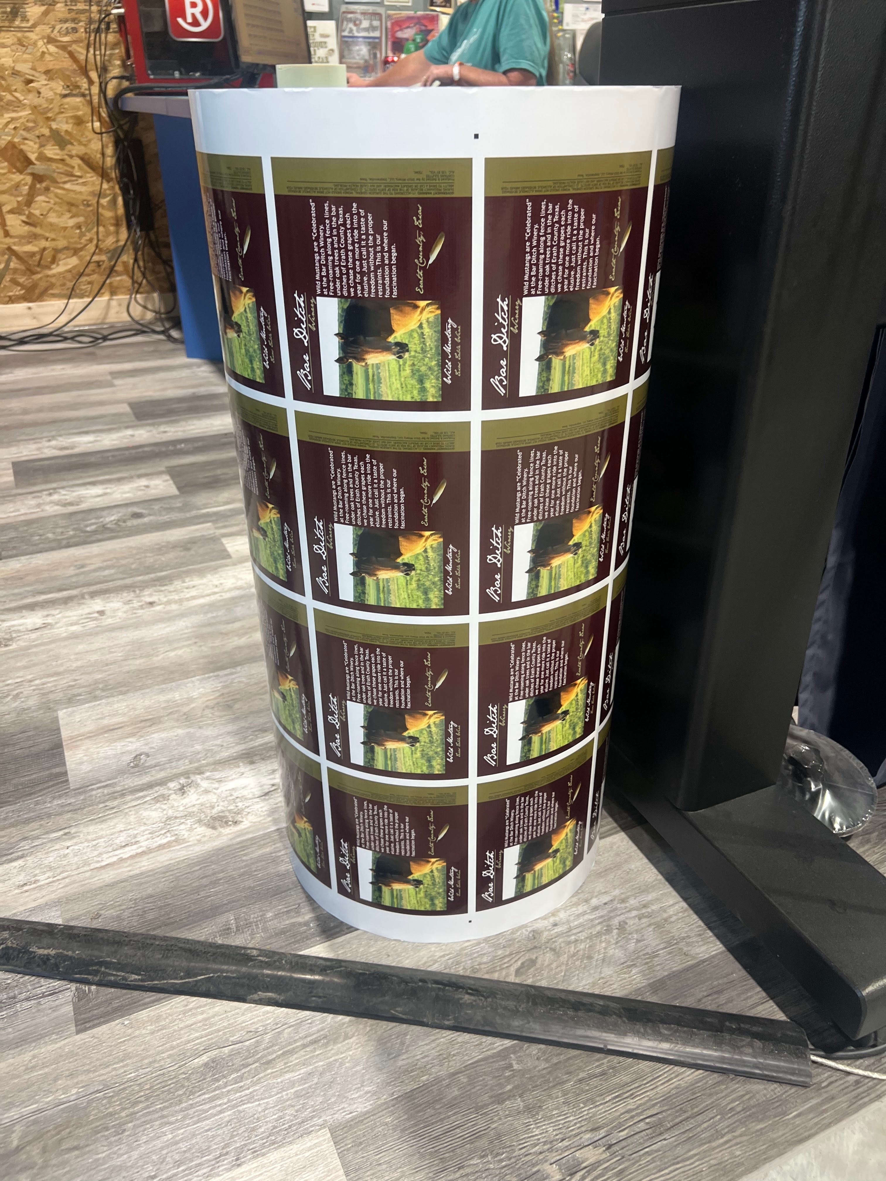 Roll of printed Bar Ditch Winery wine bottle labels ready for application