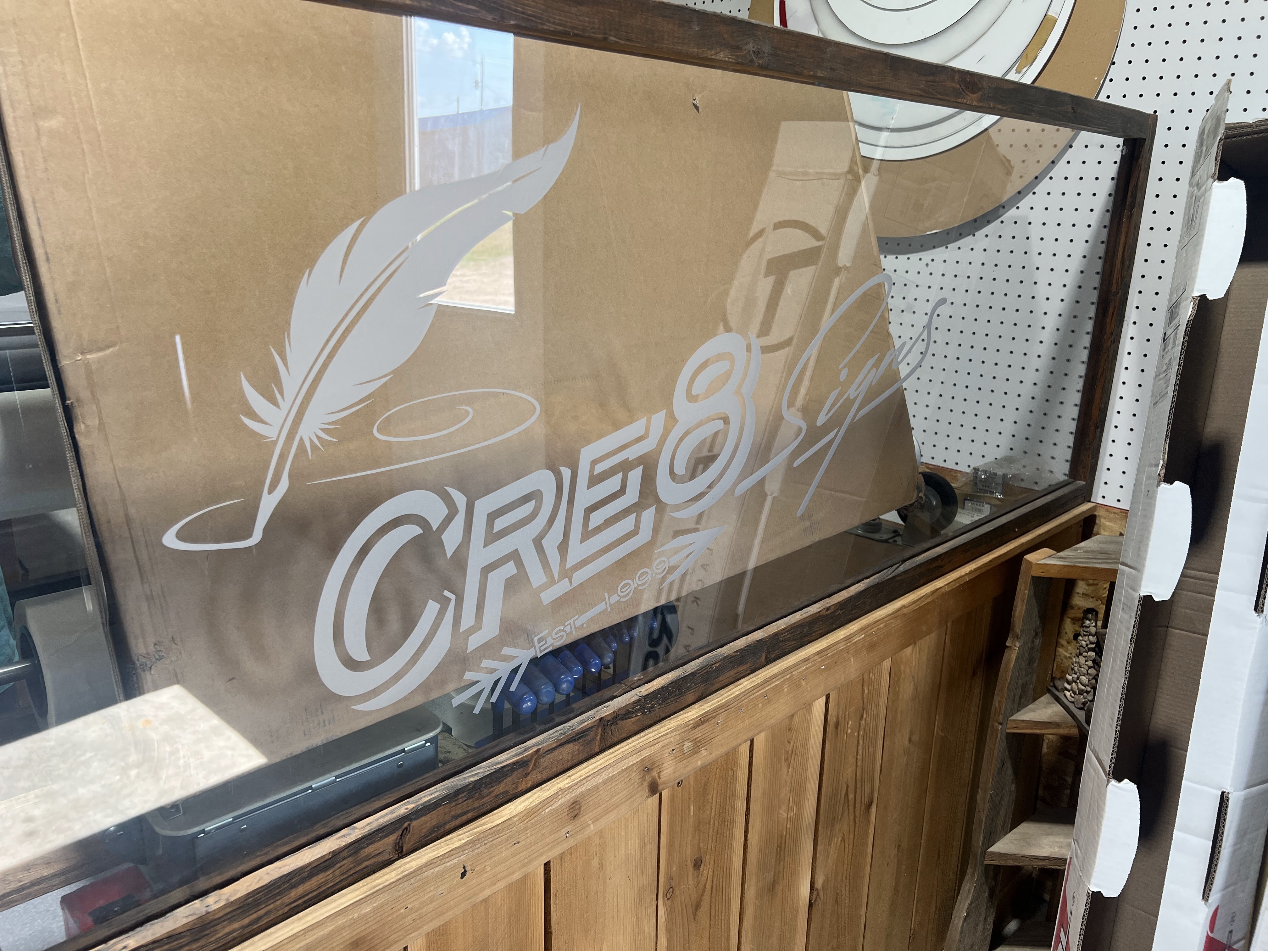 Etched glass Cre 8 Signs logo applied to storefront window in Dublin, TX